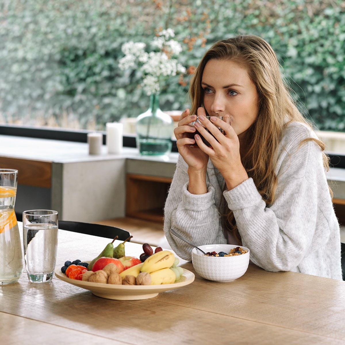 Pharmanex TR90 30-day weight management program lifestyle picture with woman enjoying a healthy meal.